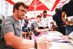 Fernando Alonso, McLaren, and Stoffel Vandoorne, McLaren, sign autographs for fans