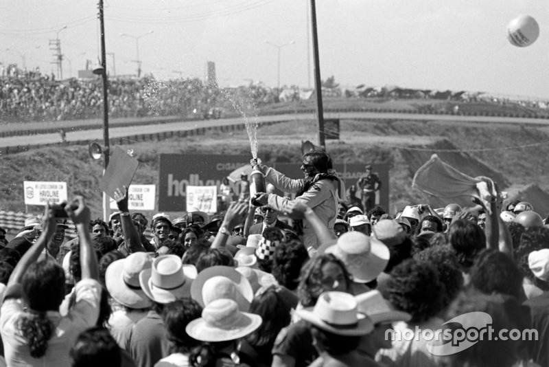 Winner Emerson Fittipaldi celebrates with his adoring fans