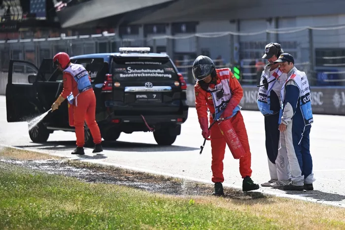 Marshals extinguish a trackside fire in Q2 during qualifying 