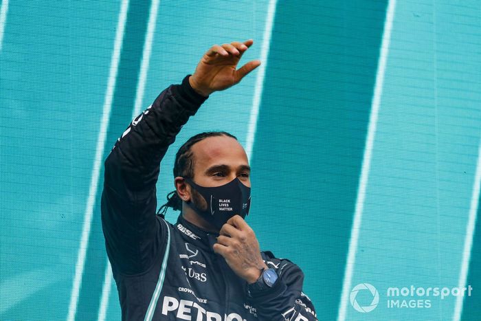 Lewis Hamilton, Mercedes-AMG F1, waves on the podium after winning the race, to take his 7th World Championship title