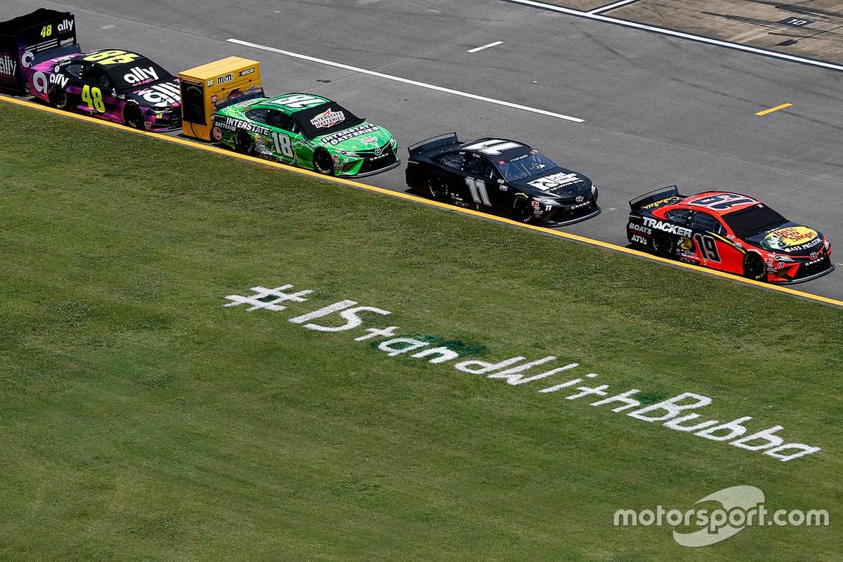 A view of pit road is seen with an #IStandWithBubba stencil painted on the grass