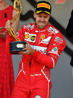 Race winner Sebastian Vettel, Ferrari celebrates on the podium with the trophy