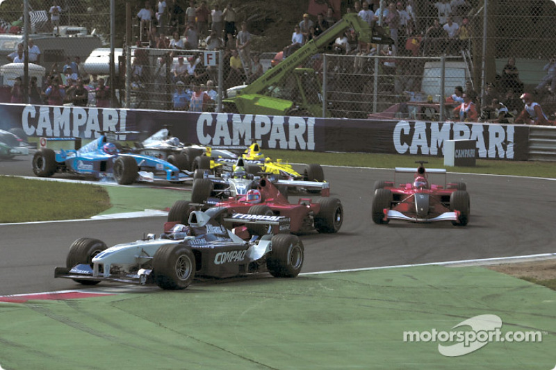 First corner: Juan Pablo Montoya leading Rubens Barrichello and Michael Schumacher