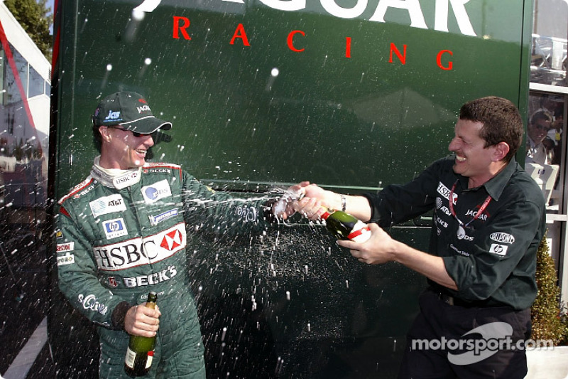 Eddie Irvine celebrates podium finish