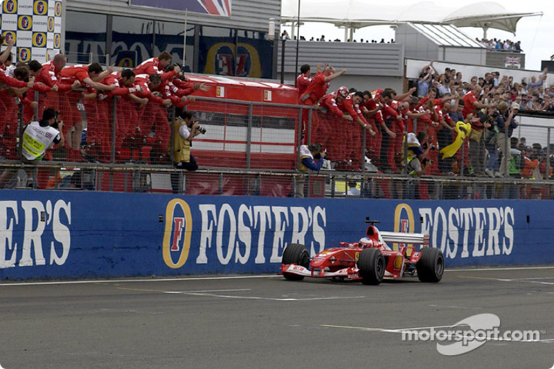 Rubens Barrichello and Ferrari team members celebrate victory