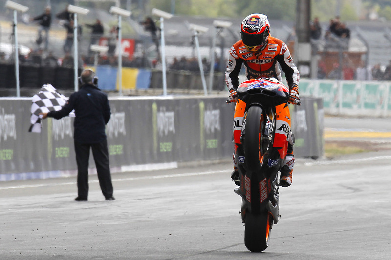 Race winner Casey Stoner celebrates