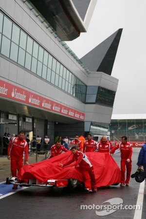 Ferrari Mechanics pushing the car down to Parc Ferme