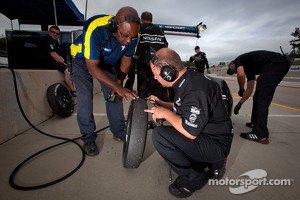 Michelin and Nissan DeltaWing technicians check a front tire of the #0 Nissan DeltaWing