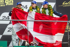 LMGTE Pro podium: third place Darren Turner, Stefan Mücke, Peter Dumbreck with a Danish flag for Allan Simonsen