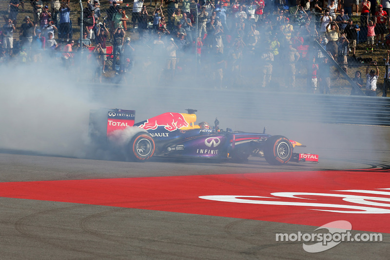 Race winner Sebastian Vettel, Red Bull Racing RB9 celebrates at the end of the race with some doughn