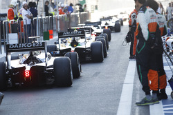 GP2 cars queue in the pit lane