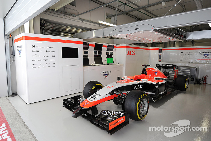 The Marussia F1 Team MR03 of Jules Bianchi, sits prepared, but not racing, in the pit garage