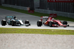 Lewis Hamilton, Mercedes AMG F1 W06 and Sebastian Vettel, Ferrari SF15-T battle for the lead of the race