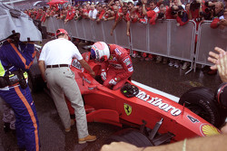 Michael Schumacher saluda al ganador de la carrera Rubens Barrichello, Ferrari en el parc ferme