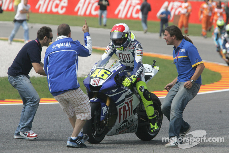 Race winner Valentino Rossi takes the checkered flag