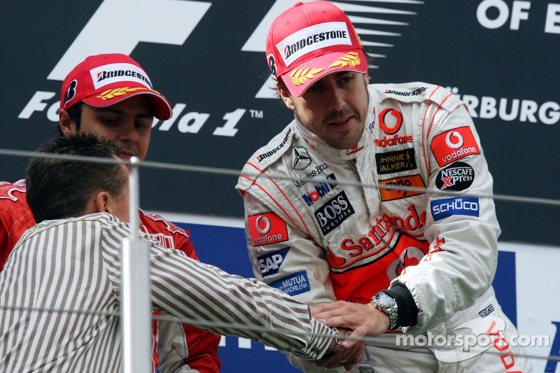 Podium: race winner Fernando Alonso celebrates with Michael Schumacher