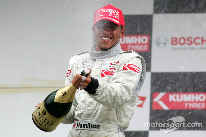 Podio: terzo posto Lewis Hamilton spruzza champaign