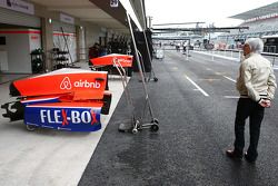 Bernie Ecclestone, walks past the Manor Marussia F1 Team pit garage