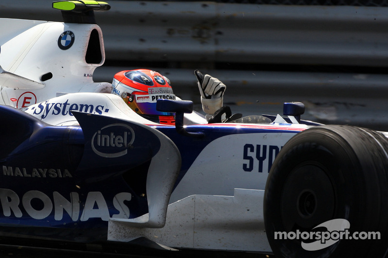 Race winner Robert Kubica celebrates