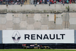 Pastor Maldonado, Lotus F1 E23 passes a Renault advertising hoarding